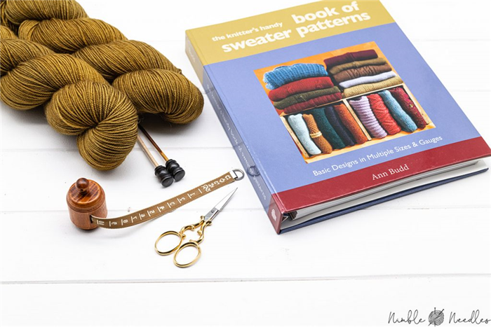 the knitter's handy sweater book of patterns by ann budd on a table