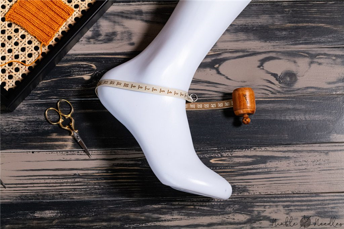 измерение стопы в самом широком месте с помощью ленты, чтобы определить максимальную окружность носков